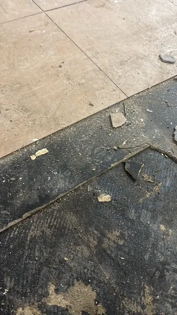 Black bitumen mastic floor removal in a W13 flat